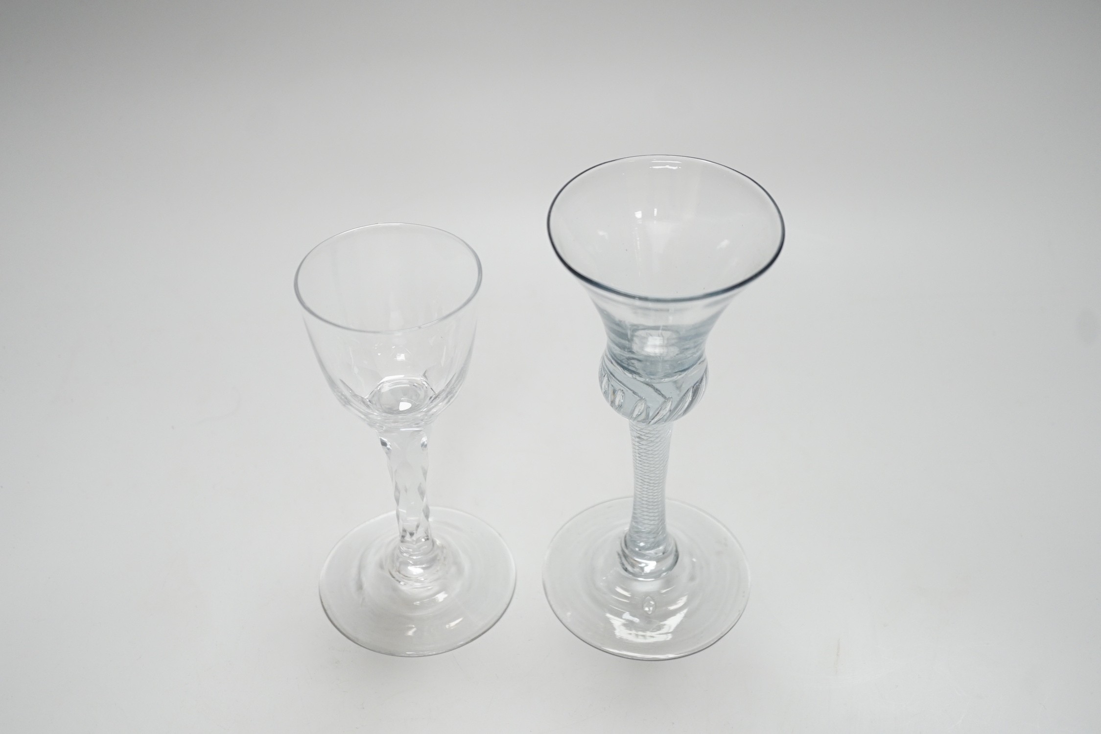 An 18th century air twist stem glass and a facet stemmed glass, tallest 18cms high